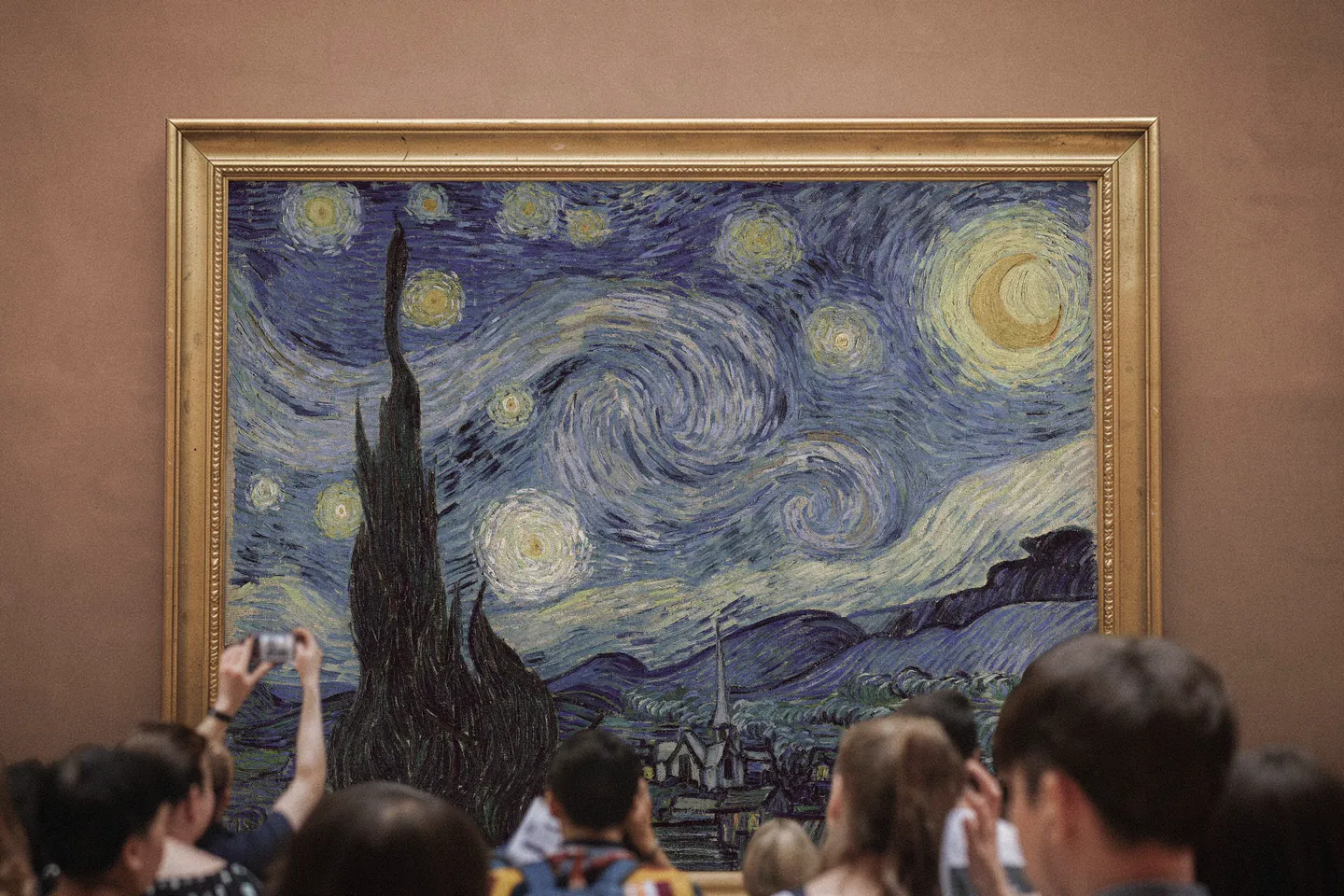 Vincent van Gogh's Starry Night displayed in a gold frame on a warm museum wall, with viewers photographing it from behind. Cover image for Still Night — an interactive audiovisual instrument that transforms the painting into a playable system grounded in crossmodal perception research.