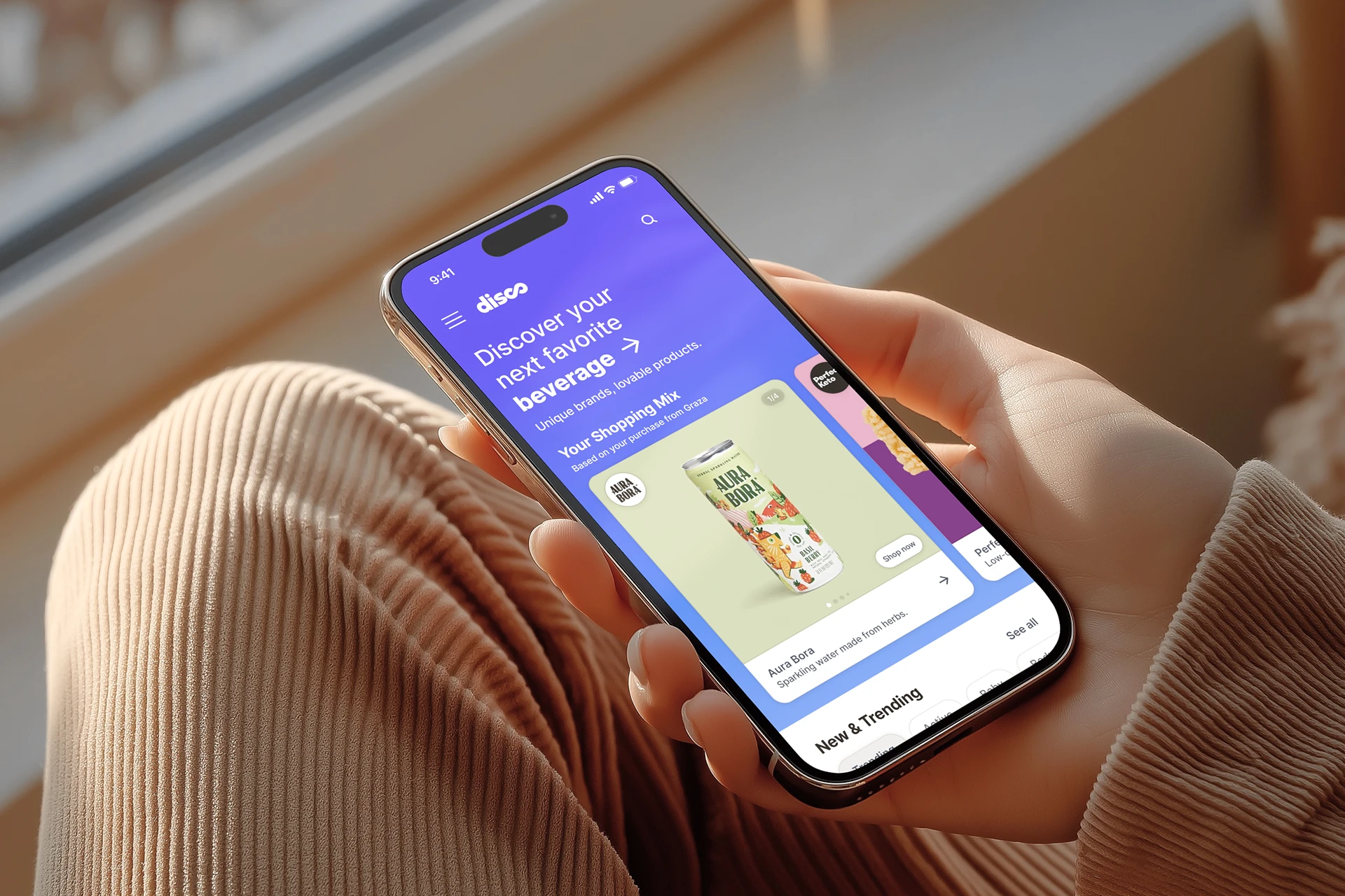Hands holding a phone showing The Disco Collective's shopping feed, with beverage brands grouped under Your Shopping Mix and New & Trending. Part of a case study on browse-first information architecture for product discovery.